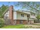 The home features a brick chimney and partial brick facade, along with a small deck at 1800 Centaur Village Dr, Lafayette, CO 80026