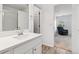 Bright bathroom features a quartz countertop vanity and doorway leading to main bedroom at 9031 Apache Plume Dr # E, Parker, CO 80134