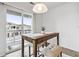 Bright dining area featuring a modern light fixture and sliding glass doors to a patio at 9031 Apache Plume Dr # E, Parker, CO 80134