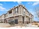 Beautiful townhome featuring a two-car garage, inviting entryway, and architectural details at 9031 Apache Plume Dr # E, Parker, CO 80134