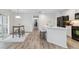 Modern kitchen with white cabinets and black appliances in an open living space at 9031 Apache Plume Dr # E, Parker, CO 80134