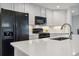 Well-lit kitchen with black appliances, white cabinets and solid surface countertop at 9031 Apache Plume Dr # E, Parker, CO 80134