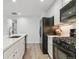 Modern kitchen with white cabinets, black appliances and solid surface countertops at 9031 Apache Plume Dr # E, Parker, CO 80134