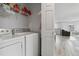 Convenient laundry room complete with washer, dryer, and storage, adjacent to a living space at 9031 Apache Plume Dr # E, Parker, CO 80134