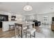 Open living space featuring a kitchen island, dining area, and living room furniture at 9031 Apache Plume Dr # E, Parker, CO 80134