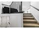 Carpeted staircase leading to the upper level of a modern townhome at 9031 Apache Plume Dr # E, Parker, CO 80134