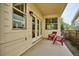 Charming back patio area with comfortable red chairs and open views to the yard at 10671 E 28Th Ave, Denver, CO 80238