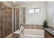 Clean bathroom with a glass-doored shower, a built-in tub, and modern fixtures at 10671 E 28Th Ave, Denver, CO 80238