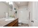Tidy bathroom featuring a tub-shower combo with white tile, vanity, and decor at 10671 E 28Th Ave, Denver, CO 80238