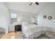 Bright bedroom with a ceiling fan, natural light from two windows, and light walls and flooring at 10671 E 28Th Ave, Denver, CO 80238