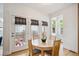 The breakfast nook features a wood table and chairs with natural light from windows and glass doors at 10671 E 28Th Ave, Denver, CO 80238