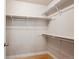 Walk-in closet with shelves and hanging rods and light-colored hardwood flooring at 10671 E 28Th Ave, Denver, CO 80238