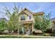 Charming two-story home featuring a welcoming front porch and well-maintained landscaping at 10671 E 28Th Ave, Denver, CO 80238