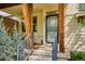 Cozy front porch with wood columns, modern railings and welcoming entrance door at 10671 E 28Th Ave, Denver, CO 80238