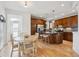 Modern eat-in kitchen featuring stainless steel appliances, a center island, and stylish cabinetry at 10671 E 28Th Ave, Denver, CO 80238