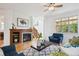 Comfortable living room with a fireplace, hardwood floors, and plenty of natural light at 10671 E 28Th Ave, Denver, CO 80238