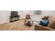 Relaxing living room with cozy carpet, sofa, TV, a side table, window, and an orange chair at 10671 E 28Th Ave, Denver, CO 80238