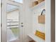 A mud room with a bench, hooks, and shelving provides an organized space for storing coats and bags at 10671 E 28Th Ave, Denver, CO 80238