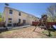 Large backyard with a patio, play set, and ample lawn space at 817 Pintail Ave, Brighton, CO 80601