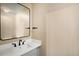 A modern half bath features a black framed mirror, vanity, and modern fixtures at 817 Pintail Ave, Brighton, CO 80601