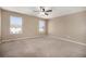 Bright bedroom with neutral tones, carpet, and ceiling fan at 817 Pintail Ave, Brighton, CO 80601