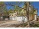 A charming townhouse with a two-car garage and light-yellow siding, beautiful tree and blue skies at 817 Pintail Ave, Brighton, CO 80601