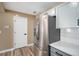 A kitchen featuring a stainless steel fridge and gray cabinets with white subway-tile backsplash at 817 Pintail Ave, Brighton, CO 80601