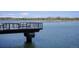 Scenic lake view with serene waters, mountains, and a wooden platform for relaxing at 817 Pintail Ave, Brighton, CO 80601