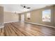 A large living room featuring hardwood floors, big windows, a fan and slider doors at 817 Pintail Ave, Brighton, CO 80601