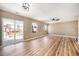 A large living room featuring hardwood floors, a sliding glass door, and a modern ceiling fan at 817 Pintail Ave, Brighton, CO 80601