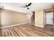 A large living room featuring an open floor plan, hardwood floors, and a modern ceiling fan at 817 Pintail Ave, Brighton, CO 80601