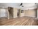 A large living room featuring an open floor plan, with hardwood floors, and a staircase at 817 Pintail Ave, Brighton, CO 80601