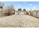 Large backyard with a patio and a mix of sparse grass and leaves, surrounded by a wooden fence at 1920 Ulster St, Denver, CO 80220