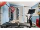 Home gym with stationary bike, free weights, and light grey wood look floors at 1920 Ulster St, Denver, CO 80220