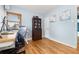 Bright home office with hardwood floors, a light blue wall, and a dark brown bookcase at 1920 Ulster St, Denver, CO 80220