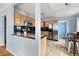 A modern kitchen with wood cabinets, stainless steel appliances, and an eat-in dining area at 1920 Ulster St, Denver, CO 80220