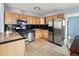 Well-equipped kitchen featuring stainless steel appliances and wooden cabinets at 1920 Ulster St, Denver, CO 80220