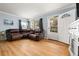 Inviting living room featuring hardwood floors, a leather sectional, and natural light at 1920 Ulster St, Denver, CO 80220