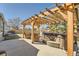 Backyard patio with a wooden pergola, a hot tub and comfortable patio furniture at 21585 E Powers Cir, Centennial, CO 80015