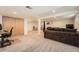 Finished basement showcasing large open carpeted area with an office and living space at 21585 E Powers Cir, Centennial, CO 80015