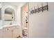 Bathroom with white vanity, brushed gold hardware, and ornate mirror at 21585 E Powers Cir, Centennial, CO 80015
