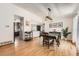 Bright dining room featuring hardwood floors, neutral walls, and modern light fixture at 21585 E Powers Cir, Centennial, CO 80015