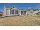 Single story ranch with gray siding, stone column accents, and attached two car garage at 21585 E Powers Cir, Centennial, CO 80015