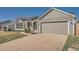 Single-story ranch home featuring a concrete driveway and attached two-car garage at 21585 E Powers Cir, Centennial, CO 80015
