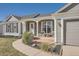 Charming home with covered front porch, stone accents, and a well-manicured lawn at 21585 E Powers Cir, Centennial, CO 80015