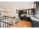 Modern kitchen with black cabinets, stainless steel appliances, and stylish brick backsplash at 21585 E Powers Cir, Centennial, CO 80015