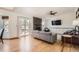 Living room with hardwood floors, a stone fireplace, and access to the outdoor patio at 21585 E Powers Cir, Centennial, CO 80015