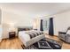 Bedroom featuring hardwood floors, large bed, and comfortable seating area at 21585 E Powers Cir, Centennial, CO 80015