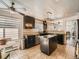 Bright kitchen featuring modern lighting, dark cabinetry, and stainless steel appliances at 673 W Belleview Ave, Englewood, CO 80110