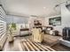 Inviting living room featuring hardwood floors, a fireplace, and large windows at 673 W Belleview Ave, Englewood, CO 80110